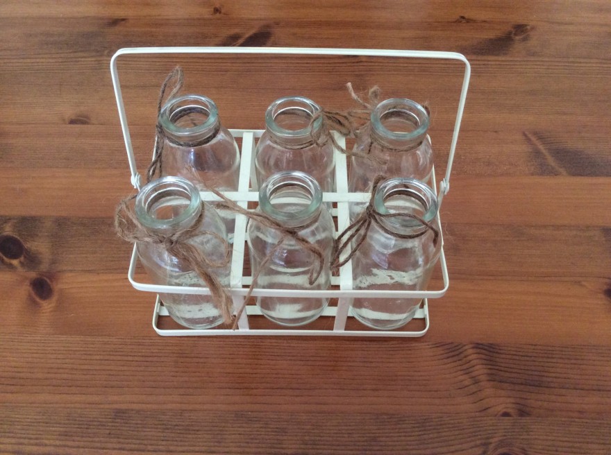 Small milk bottles in rack